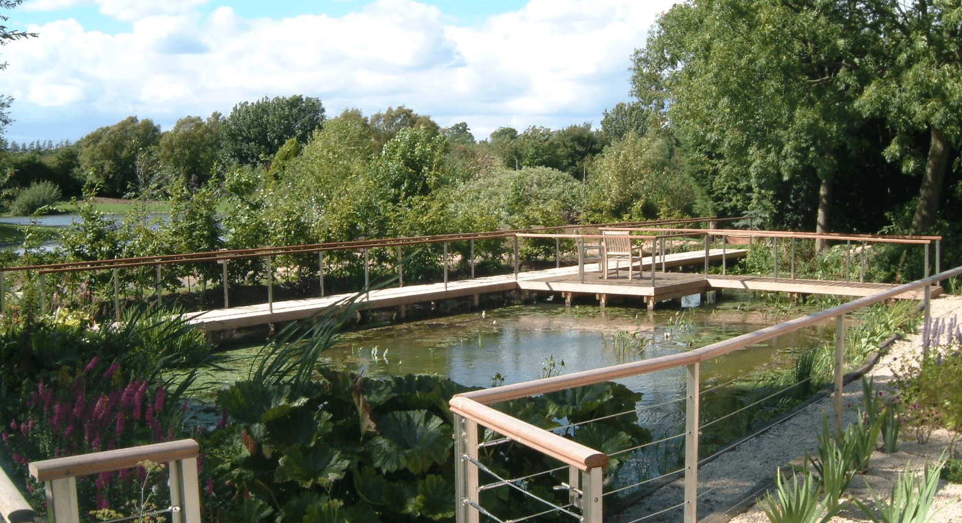 A beautifully designed decking area on a private lake, created by Cotswold Estates and Gardens.