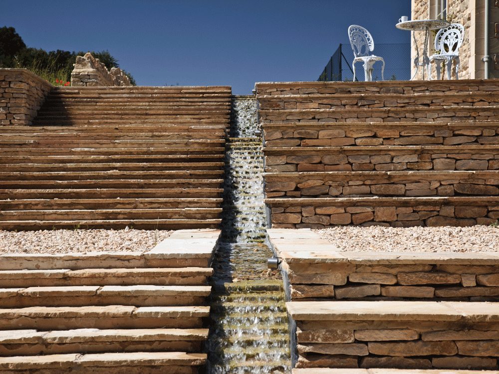 Beautifully crafted stone steps leading through a landscaped garden.