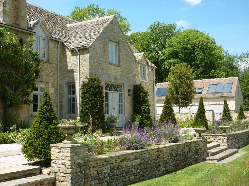 Mature topiary in the formal area of Icomb House garden, showcasing the expert landscaping by Cotswold Estates and Gardens.