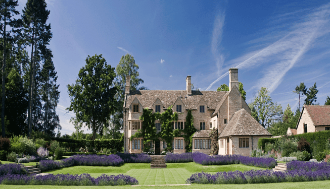 A sunken lawn with lavender borders in a garden, designed by Cotswold Estates and Gardens.