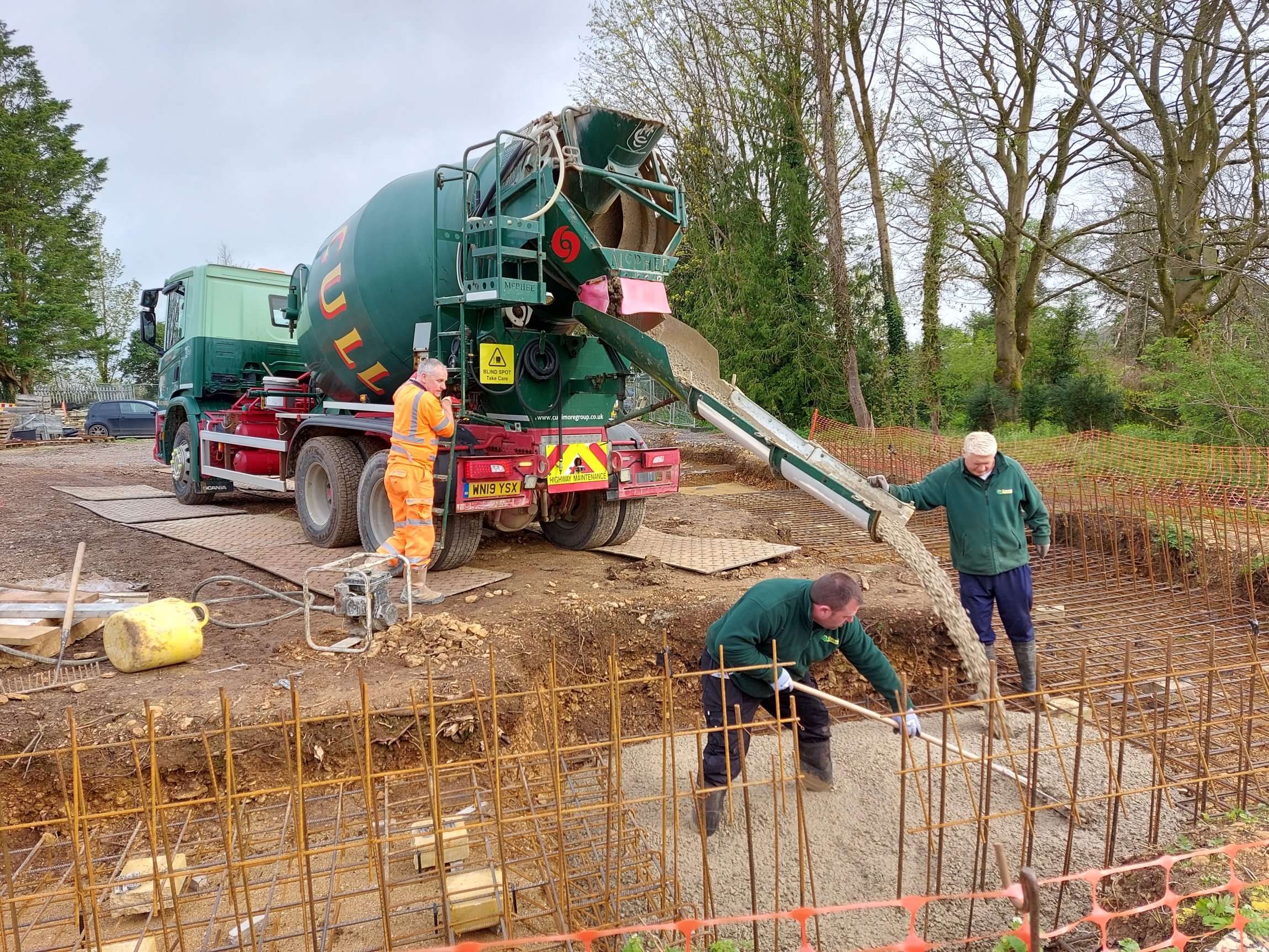 Concrete being poured for the foundation of a new unit by Cotswold Estates and Gardens.